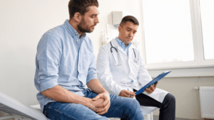 male patient sitting with doctor